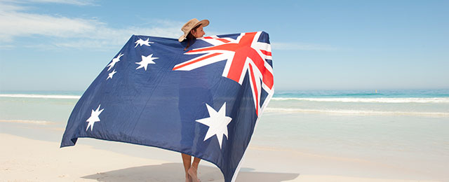 Dame med det australske flag på en strand